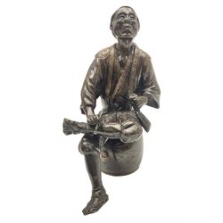 Oriental bronze figure of a gentleman, modelled seated upon barrel with a pipe in one hand and a flask in the other, H21cm