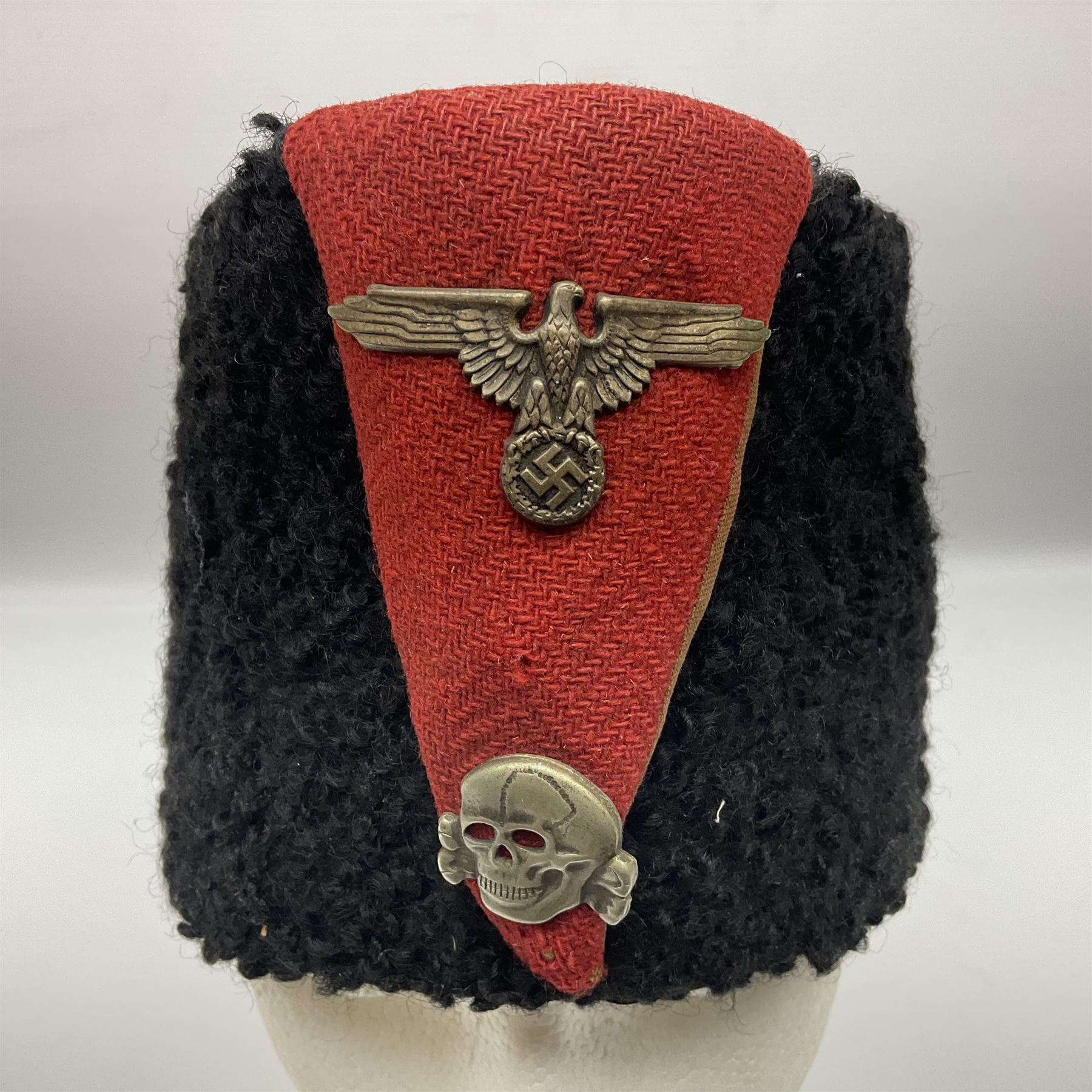 WW2 German small size Balkan style hat with 'SS' metal badges; red cloth top and flash to front with black persianelle type sides; lined in brown card with leather sweatband