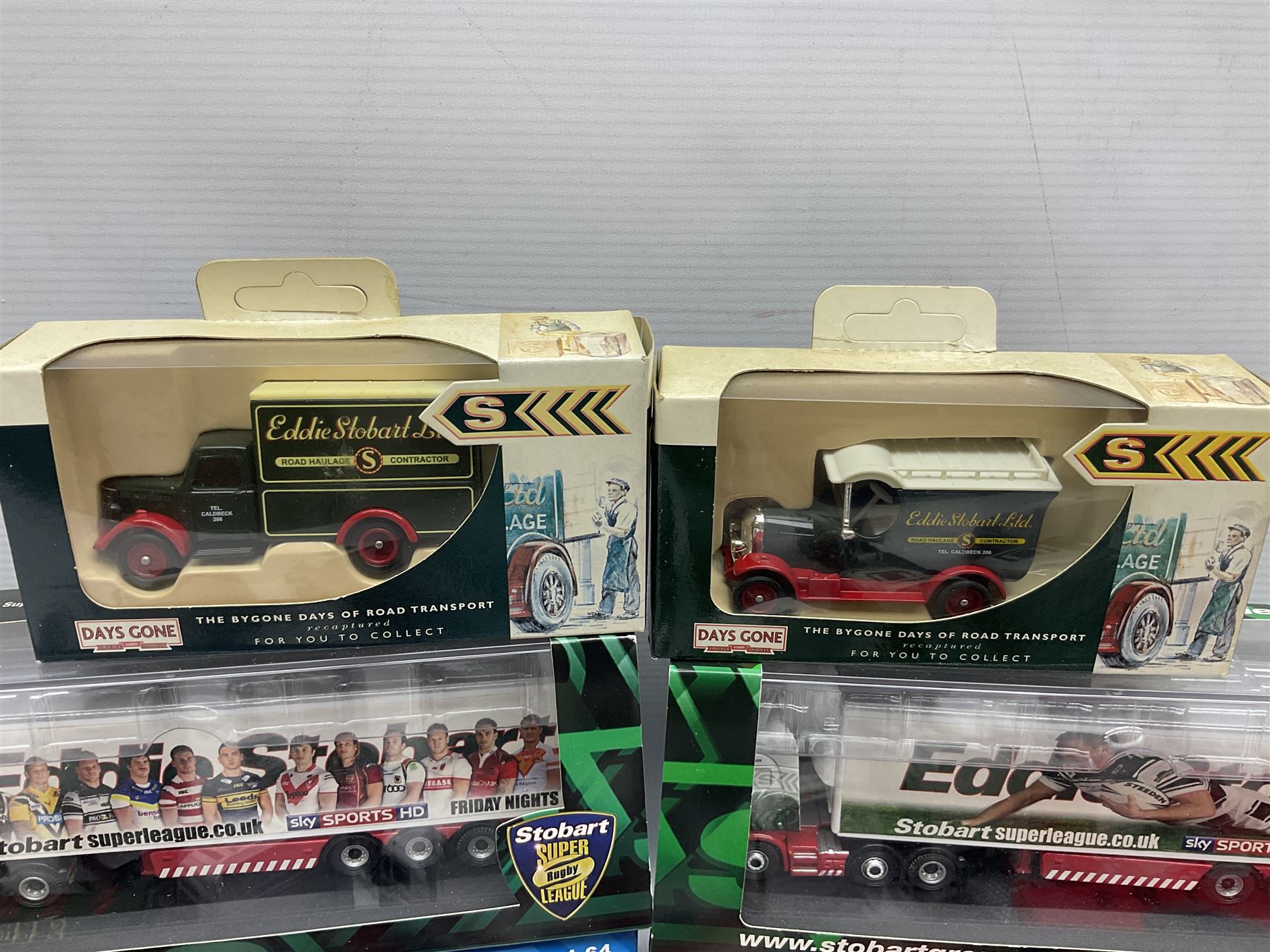 Eddie Stobart - three Oxford Die-Cast Super Rugby League lorries in perspex display cases including the two Hull Clubs; two Lledo Vanguard vans; two Days Gone vans; and Saico Truck & Trailer; all boxed; together with fourteen unboxed Corgi and other tractor/cab units etc (23)