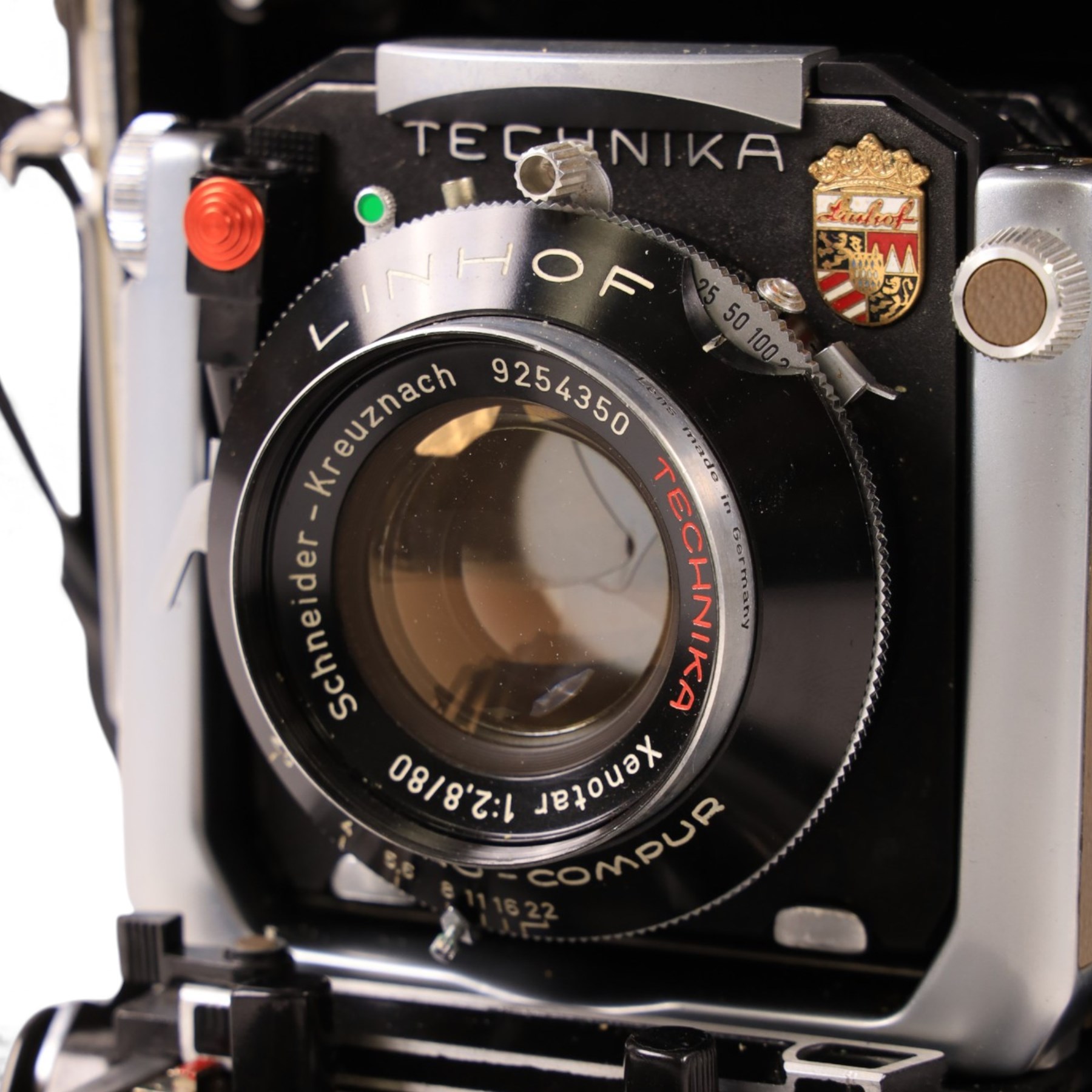 Linhof Tecnika 70 medium format press camera serial no. 1711919, with a Xenotar 1:2.8/80 lens serial no. 9254350 and a Symmar 1:5.6/180 lens serial no. 8357904, both coupled to the camera, and additional accessories including Symmar-S 5.6/100 lens, and a Carl Zeiss Jena Apo-Lanthar 40mm1:4.5 macrolens, numbered set of seven Linhof dark slides, super rollex roll film holder and anatomical grip, all contained within modern case
