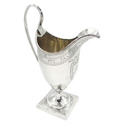 George III silver cream jug, of helmet shape with beaded rim and high curved reeded handle, the body engraved with monogramed cartouche and foliate border, hallmarked London 1792, makers mark worn and indistinct, approximate weight 3.69 ozt (115 grams)