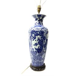 A Chinese blue and white table lamp, of slender baluster form decorated with alternate panels of landscapes and pheonix amongst blossoming peony and prunus trees, with fabric shade, lamp base H46.5cm. 