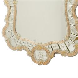 20th century Venetian glass wall mirror, the shaped plate within a mirrored frame applied with clear glass flowerheads and moulded glass edging, with etched floral decoration to the bevelled 'frameless' plates, the inner slip with ropetwist moulded glass