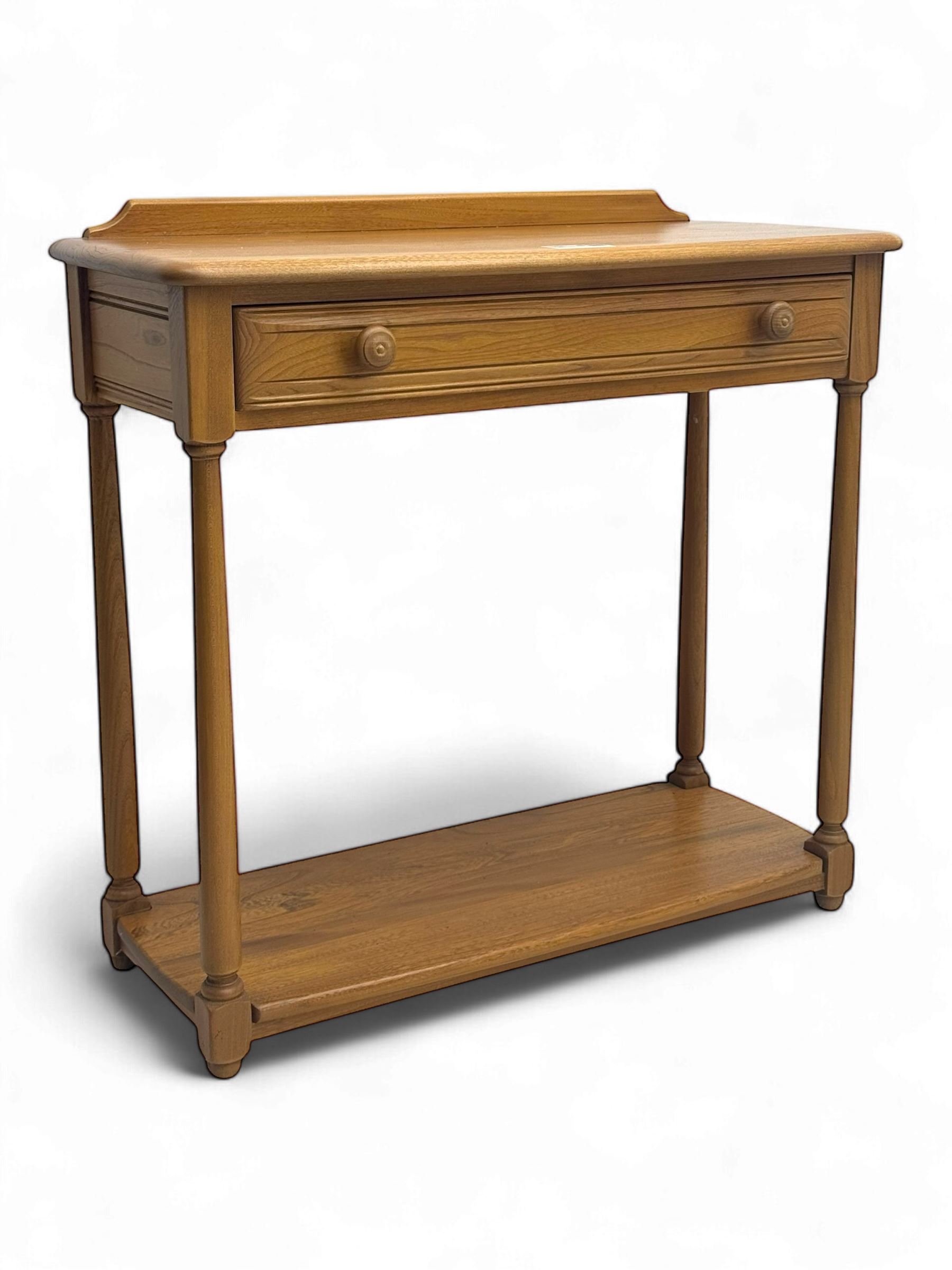 Lucian Ercolani for Ercol - mid 20th century light elm console table, rectangular top with raised gallery back over full-width frieze drawers, raised on tapered supports united by undertier 