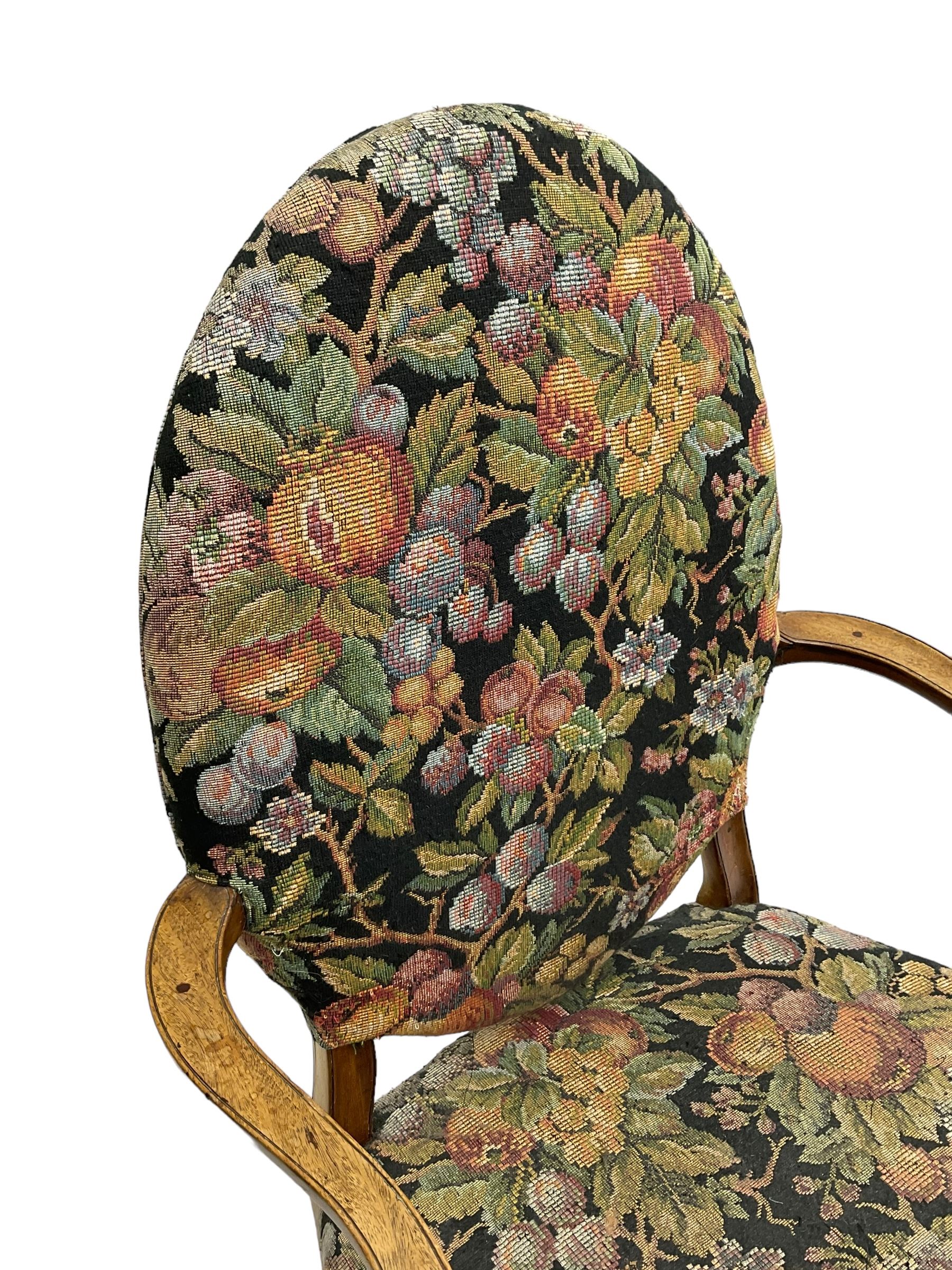 Pair of George III mahogany framed open armchairs, oval back and serpentine seat upholstered in fruit and foliage patterned fabric, shaped and moulded arms and arm supports, on square tapering moulded front supports 
