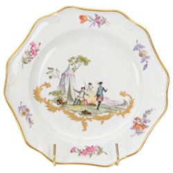 Pair of early 19th century cabinet plates, possibly Derby replacements for Frankenthal, each of faceted form with moulded shell detail to rim and gilt edge, the centre painted with an encampment with soldiers at rest, above a gold rocaille scroll and surrounded by floral sprigs to the rim, with gilt mark beneath for Frankenthal, Carl Theodor, D24cm