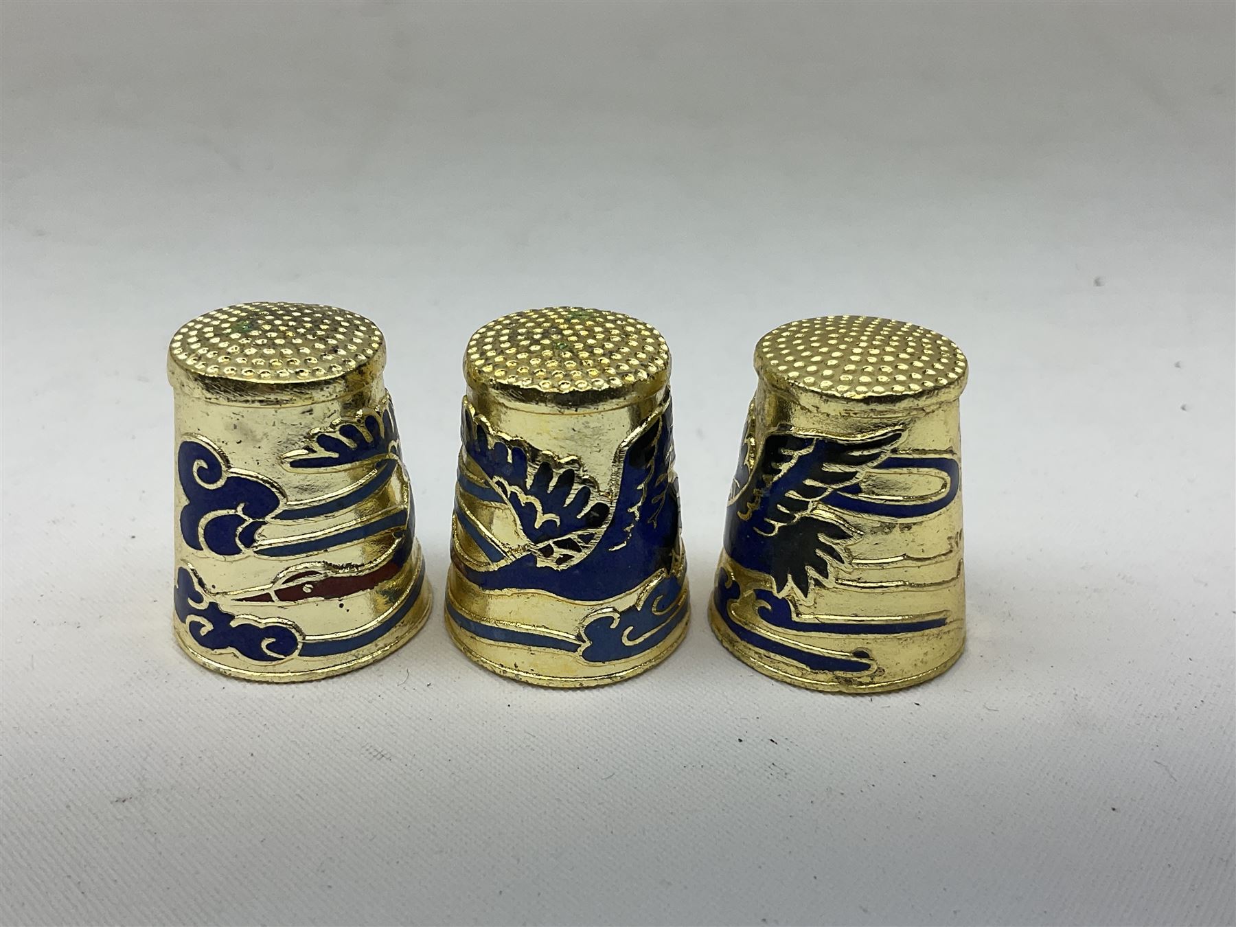 Twenty cloisonné thimbles, decorated with, flowers, birds, dragons