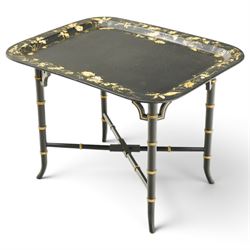 Victorian ebonised and gilt-painted papier-mâché tray on later ebonised and parcel-gilt simulated bamboo stand, the rectangular removable tray with gilt foliate and butterfly scenes with scrolling branches, the base on four ring-turned and splayed supports united by X-stretcher