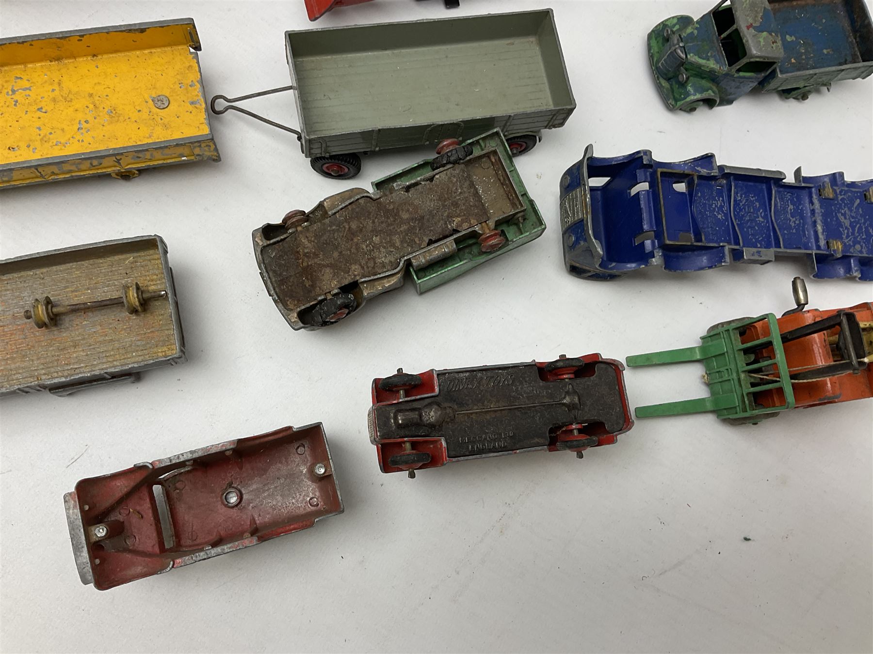 Dinky - twenty-six unboxed and playworn die-cast models including Foden Regent Tanker, two Foden lorries, Pressure Refueller No.642, Snow Plough, Elevator Loader, Foden Dump Truck, Blaw Knox Bulldozer and other commercial vehicles