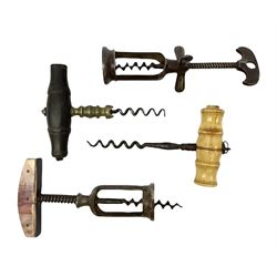 Four 19th and 20th century corkscrews, comprising turned tree straight pull example marked Robt Jones, bone handled straight pull example, twin pillar spring assisted example with 'marbled' handle, and a French twin pillar example marked Au Louvre, JP