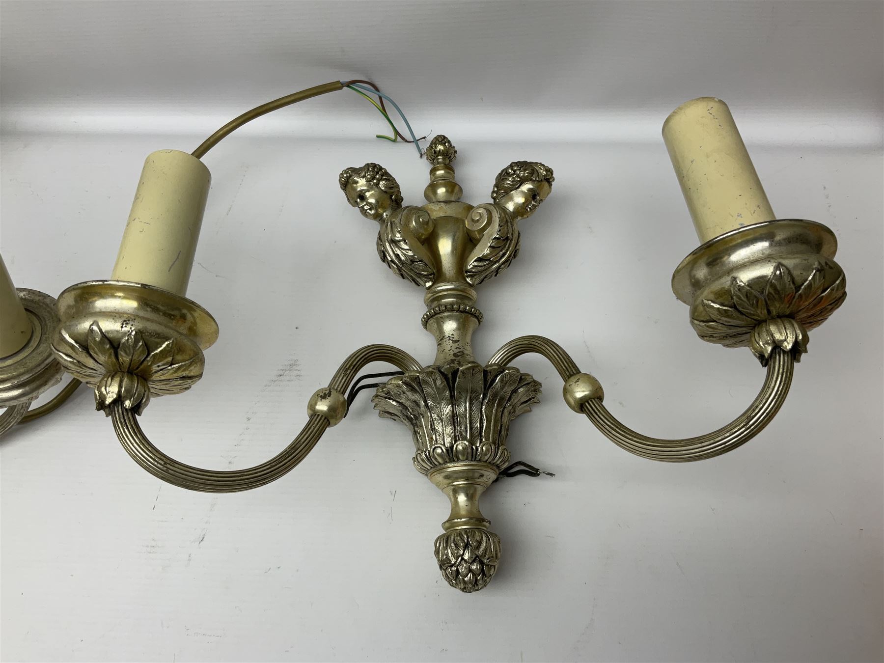 Siz branch silvered chandelier, decorated with acanthus leaves and putti, together with two matching three branch wall sconces, chandelier D65cm