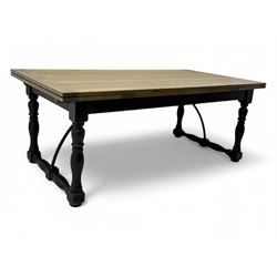 Barker & Stonehouse - large oak extending draw-leaf dining table, rectangular plank top over a black painted base, turned supports joined by shaped stretchers, extending at each end with pull-out leaves