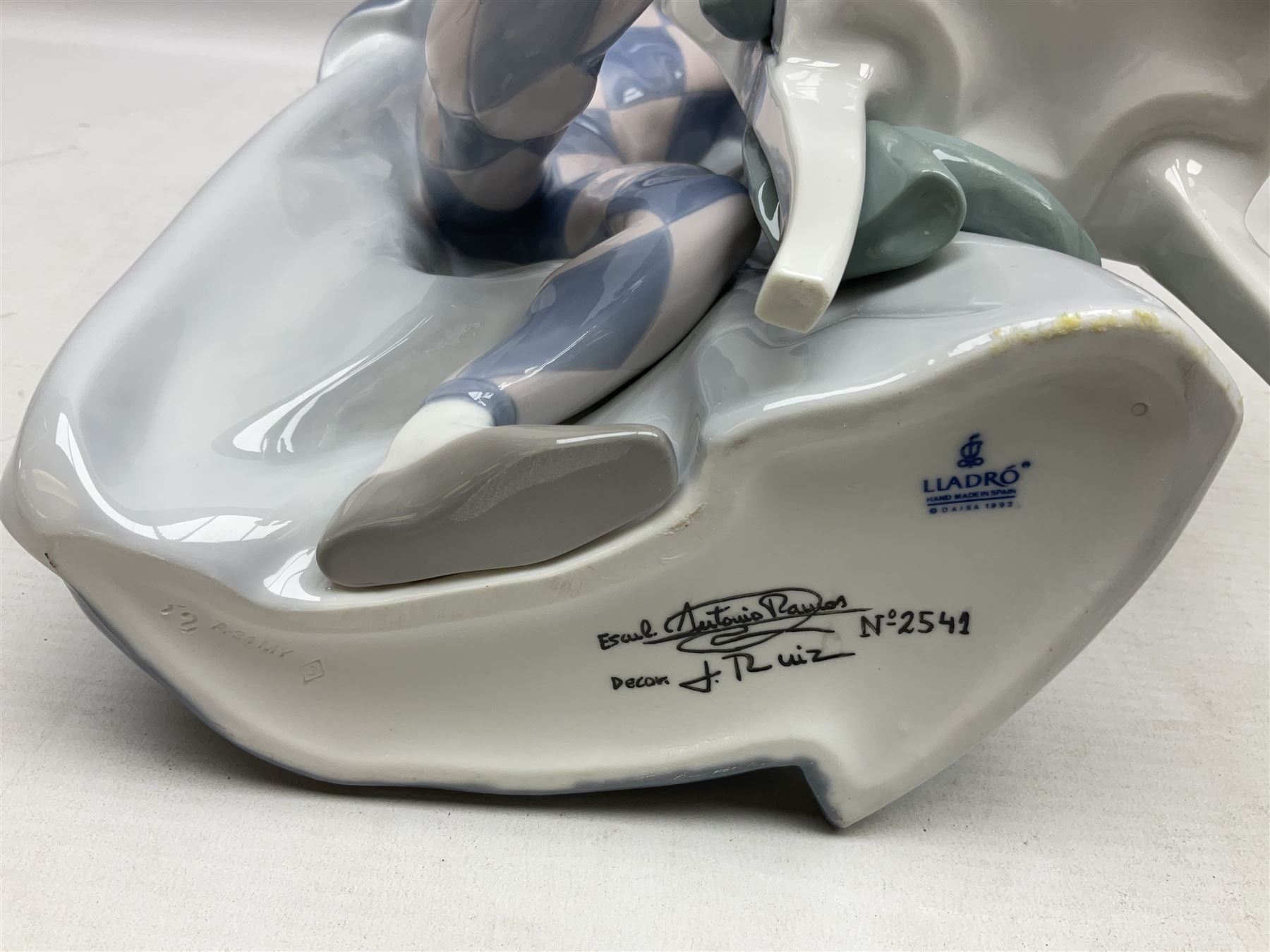 Lladro figure, Jester Serenade, modelled as a ballerina with bouquet of flowers seated before a jester playing the violin, limited edition 2541/3000, sculpted by Antonio Ramos, no 5932, with original box, year issued 1993, year retired 1994, H37cm