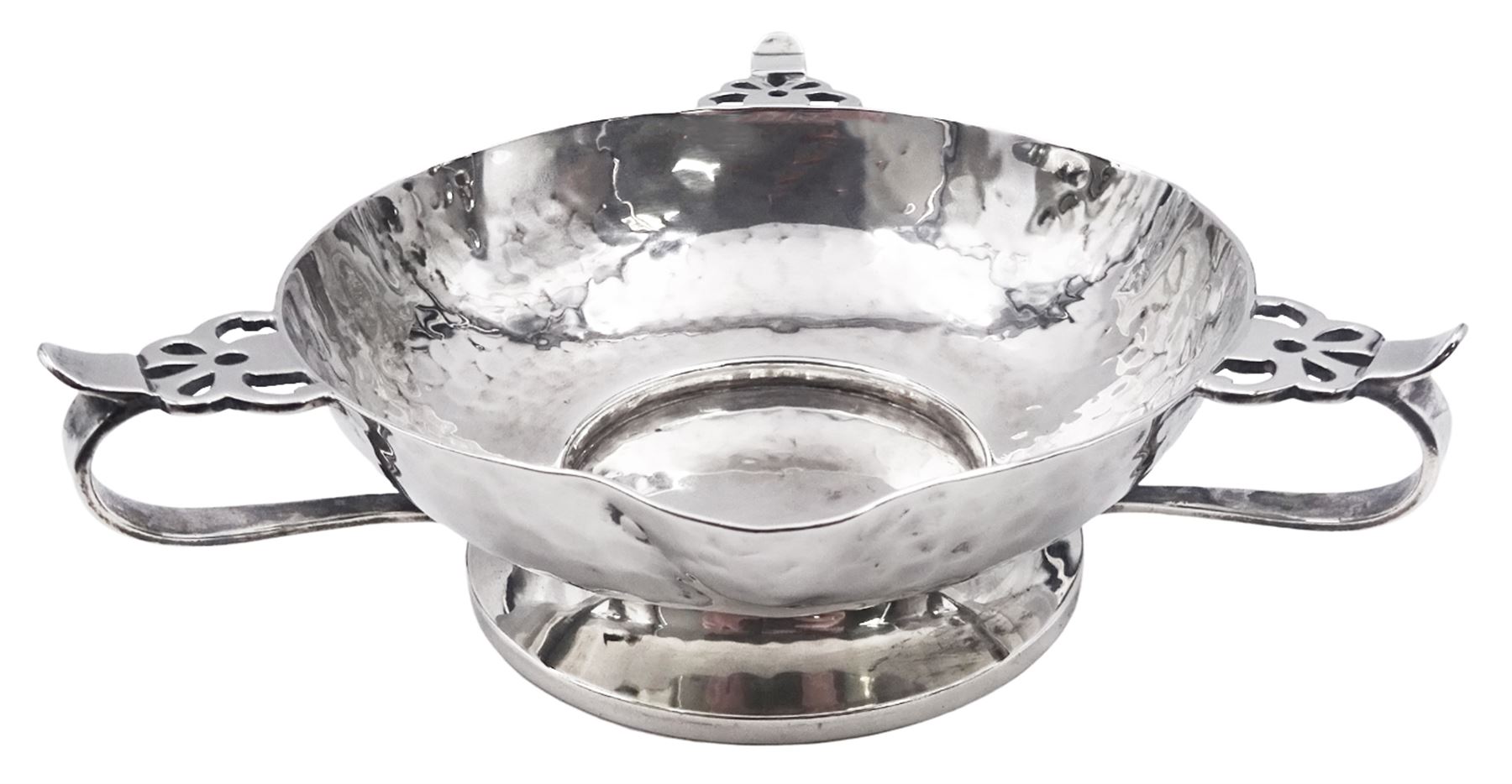 Arts & Crafts silver bowl, the planished bowl of circular form with three lips to rim, and three flower head capped curved handles, upon a circular spreading foot, hallmarked Charles Edwards, London 1904, 5.5cm D13cm, approximate weight 8.81 ozt (274 grams)
