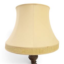 Late 19th Century mahogany standard lamp with shade, canvas beige shade, above a carved and turned column, on a carved base with pad feet