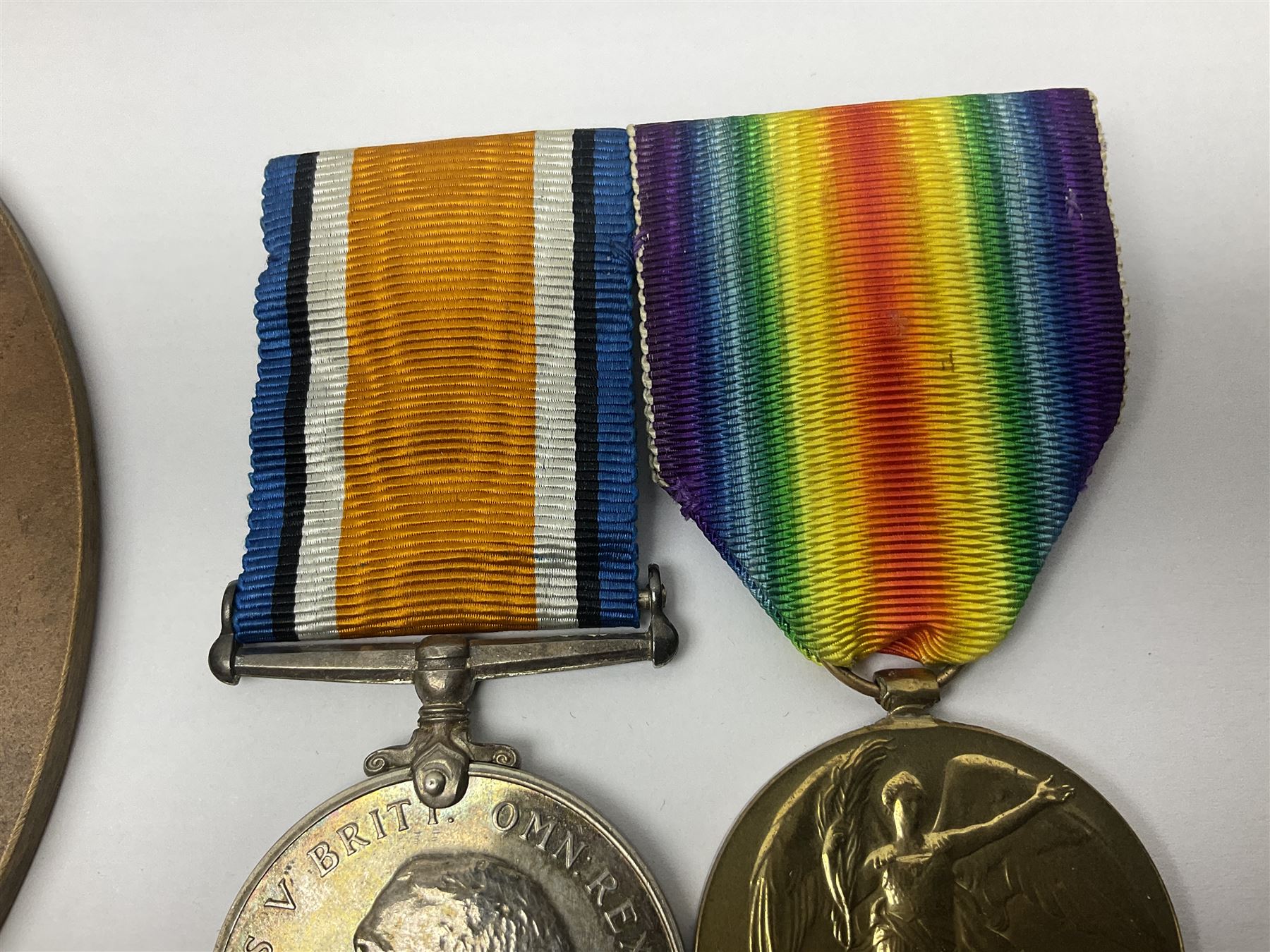 WWI pair of medals comprising British War Medal and Victory Medal awarded to G/62196 Pte. H. Ferguson R. Fus. with ribbons on wearing bar; together with bronze memorial plaque to Henry Ferguson (3)