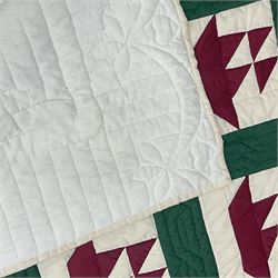 20th century quilt, with repetitive ship design to the centre within a cream red and green boarder, 227cm x 222cm