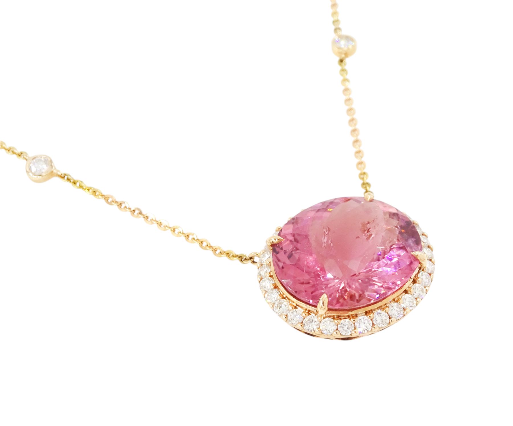 18ct rose gold pink tourmaline and diamond pendant necklace, oval cut tourmaline of 15.41 carat, surrounded by round brilliant cut diamonds, to a trace link chain necklace set with four diamonds, stamped 750, total diamond weight 1.22 carat, with World Gemological Institute report