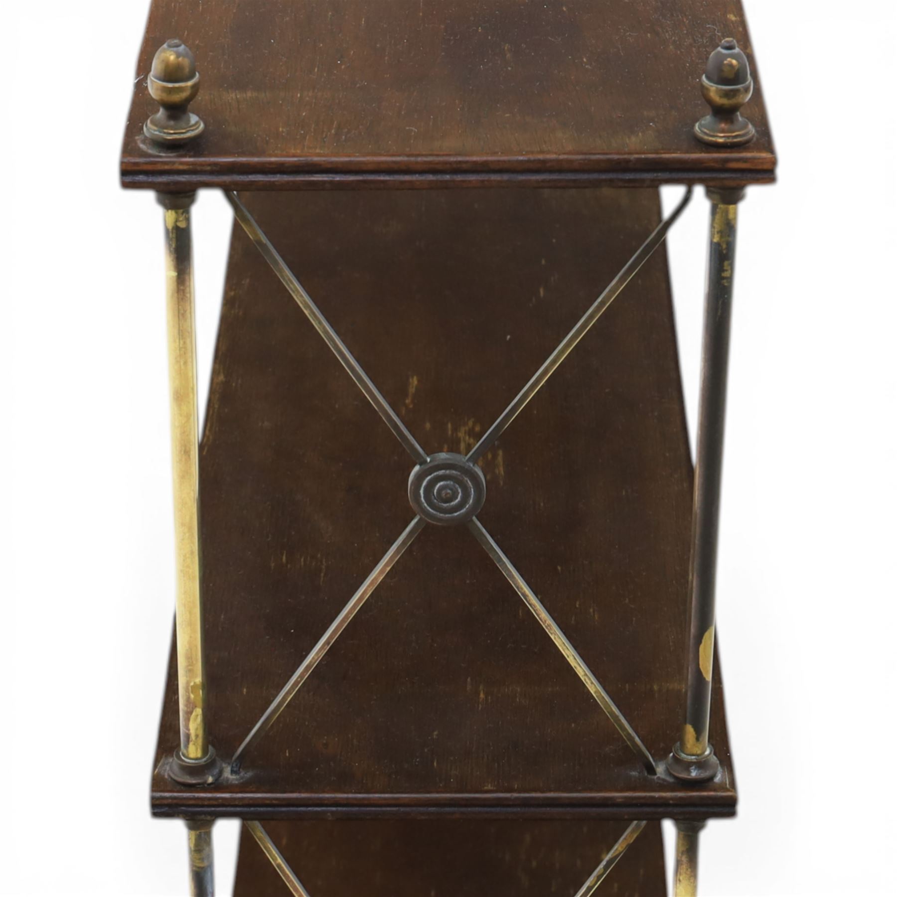 Regency brass and mahogany wall shelves circa 1820, the three shelves contained within a brass cross brace with brass finials, with wall fixings 
