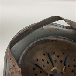 WW2 German Infantry M40 steel helmet with tropical finish and traces of single decal; with chin strap and leather liner marked 57 twice in red; back apron stamped 11 38