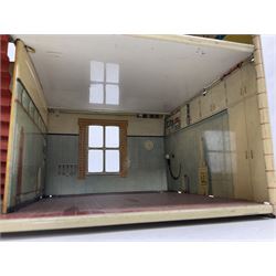 Mid-20th century Mettoy tin-plate double-fronted two-storey doll's house, the front elevation with five unglazed windows flanked by green shutters, central opening door, open back giving access to five rooms together with an attached garage, 60cm wide