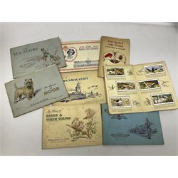 Early 20th century ephemera, to include signed photographs of Charles Boyer and Walter Pidgeon etc, a printed letter from Winston Churchill, two albums and a quantity of transfer books of Players and similar cigarette cards, including Boy Scout and Girl Guide Patrol Signs and Emblems and RAF Badges, a collection of greetings cards and postcards, a photograph album containing black and white photographs of Caius College Cambridge and guides and pamphlets on travelling Switzerland and the UK