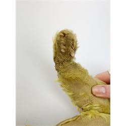 Early 20th century English teddy bear, with wood wool filled body with jointed limbs, felt covered paw pads, five claw stitching to feet and elongated arms with spoon shaped paws H14