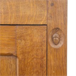 Acornman - oak adzed panelled double wardrobe, with wrought iron hinges and carved oak latch revealing a single clothes rail, with signature carved acorn to top right, by the workshop of Alan Grainger, Brandsby