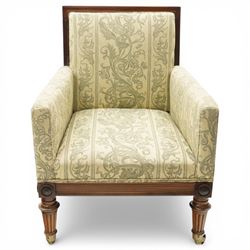 William IV rosewood framed library armchair, squared form with green on ivory ground upholstery, moulded lower seat rail with applied roundels over reeded supports, terminating to brass cups and castors