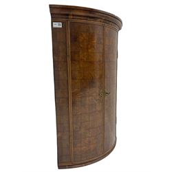 Yew wood bow front corner cupboard, projecting cornice over two doors inlaid with cubed figured end grain veneer, the interior fitted with two shelves
