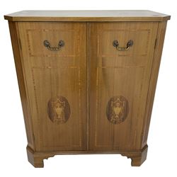 John More of Scarborough -  Edwardian Revival 'Canterbury Cabinet' inlaid mahogany cabinet, fitted with double cupboard decorated with urn motif inlays and banding, flanked by canted fluted uprights, on bracket feet
