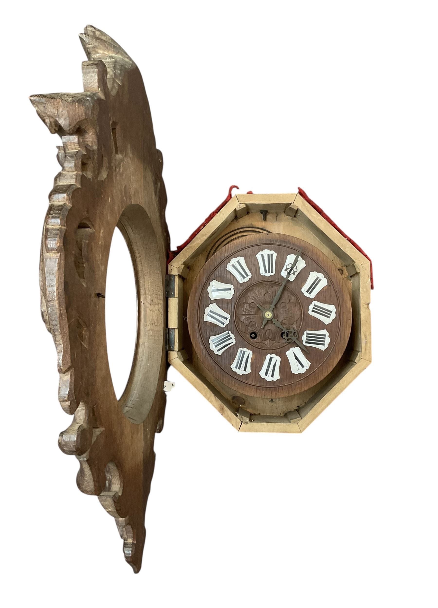 French- late 19th century carved oak wall clock c 1880, outer case with interlaced scroll carving and a carved images of fruit and wild beasts, integrated dial with porcelain cartouche Roman numerals and gothic hands, with a twin train spring driven rack striking movement striking the hours on a coiled gong.
