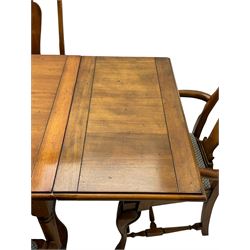 Late 20th century oak dining table, rectangular top with two draw leaf extensions, on turned supports united by moulded hayrake stretchers (180cm - 278cm x 90cm, H76cm); set of eight (6+2) oak dining chairs, shaped cresting rail over shaped splat back, upholster drop-in seat, on cabriole supports united by turned H-shaped stretchers 