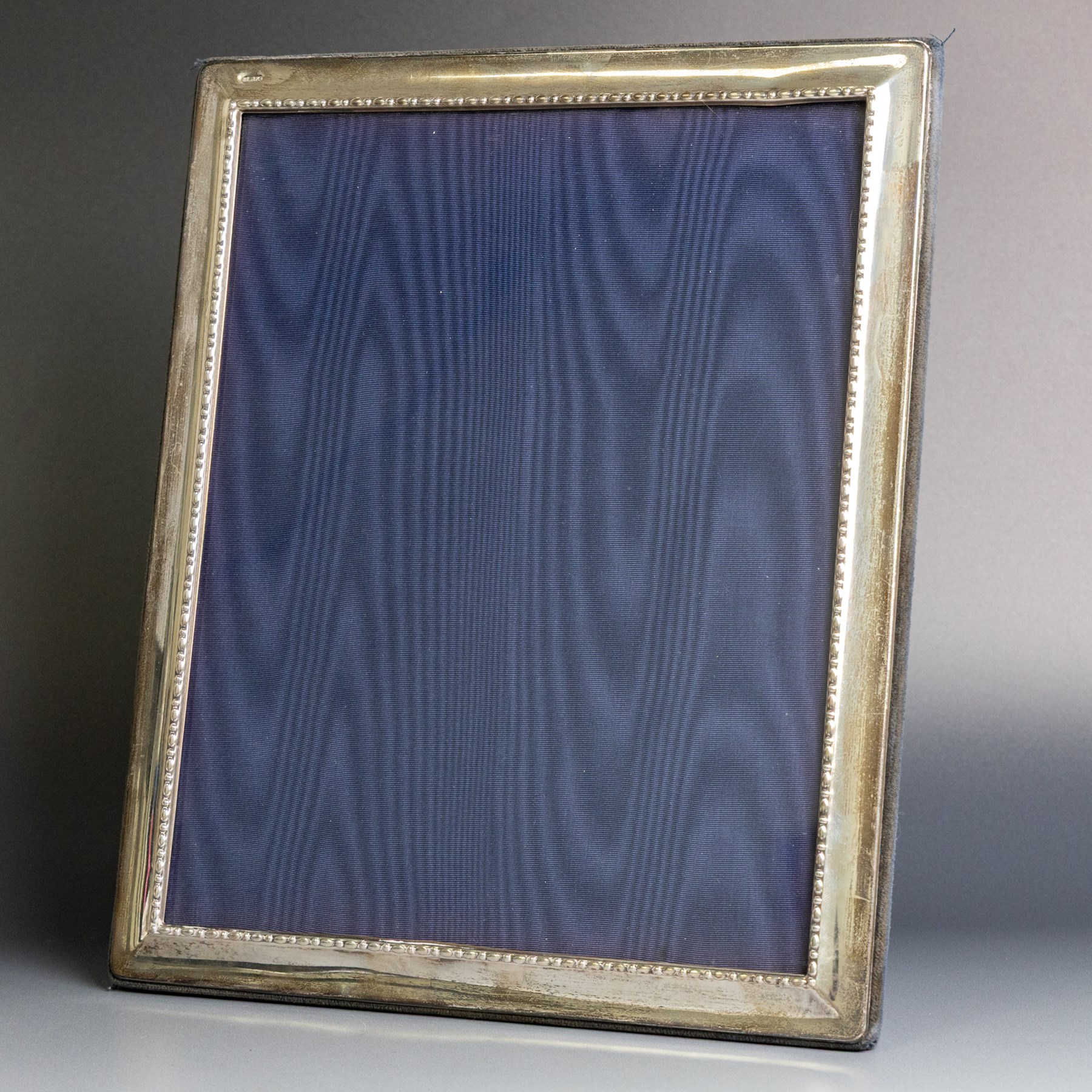 Late 20th century silver photograph frame, rectangular with beaded decoration to inner edge, blue velvet easel style support verso, hallmarked Carrs of Sheffield Ltd, Sheffield 1995