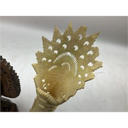 Hardwood bust of an Indoniesian Goddess, carved wearing a pierced headdress, from Klungkung, Bali, H20cm, together with a pair of bone carvings of deity figures, and a carved wood Netsuke in the form of a Chinese dragon