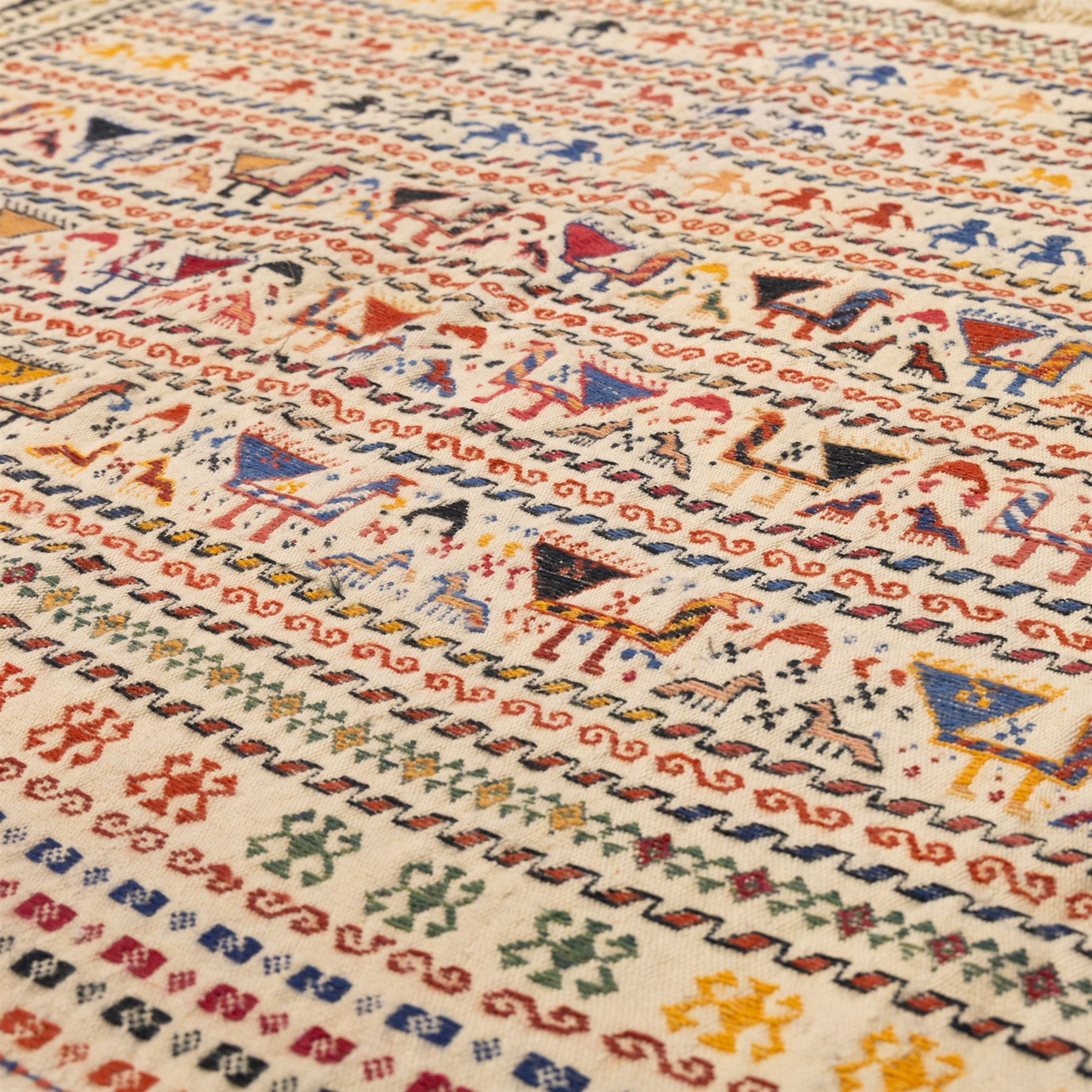 South West Persian Qashqai flatweave kilim horse cover, woven in flatweave with horizontal bands of stylized animals and geometric motifs, featuring repeated rows of horses and camels and abstract figures interspersed with serrated and meander bands, enclosed within simple geometric borders 
