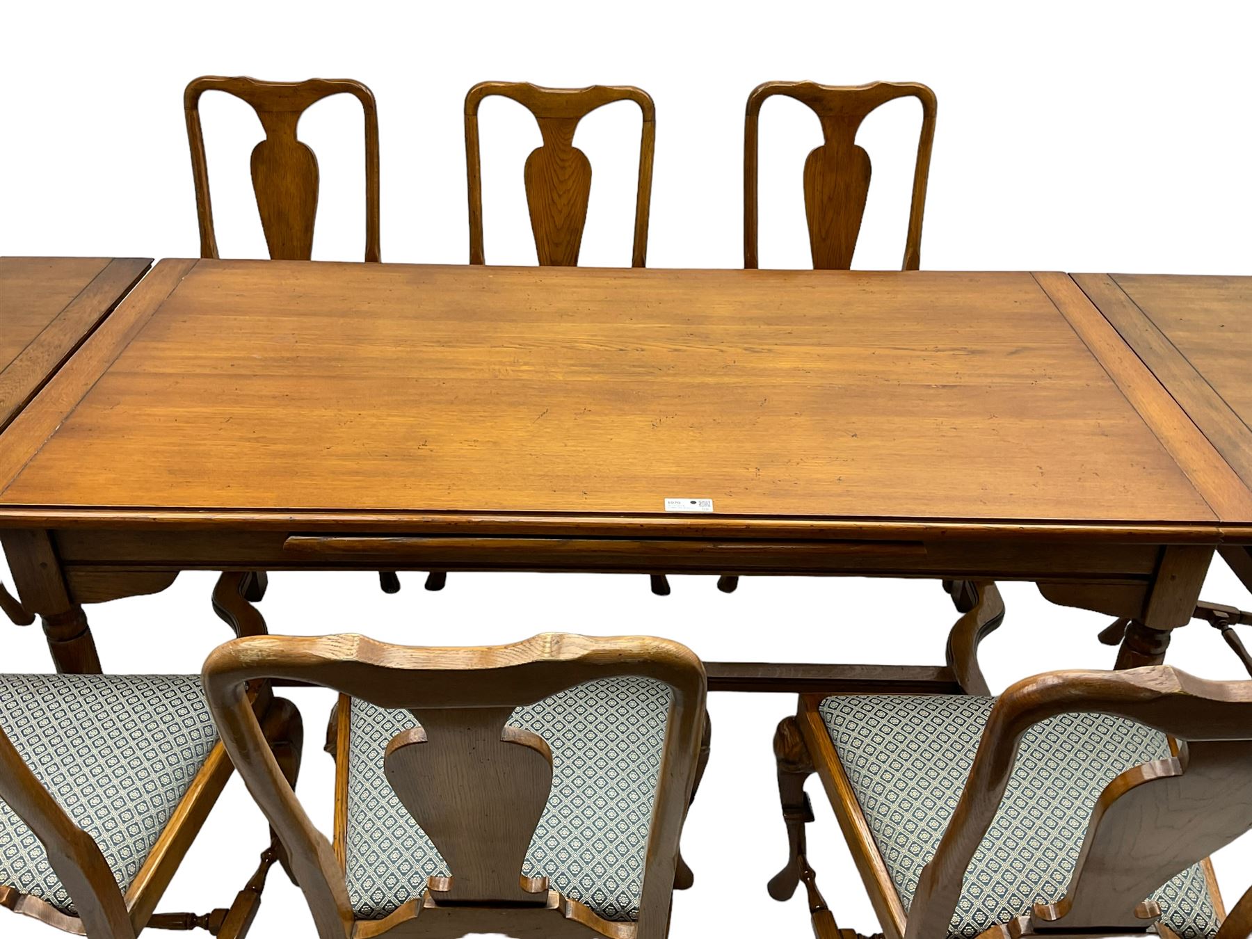 Late 20th century oak dining table, rectangular top with two draw leaf extensions, on turned supports united by moulded hayrake stretchers (180cm - 278cm x 90cm, H76cm); set of eight (6+2) oak dining chairs, shaped cresting rail over shaped splat back, upholster drop-in seat, on cabriole supports united by turned H-shaped stretchers 