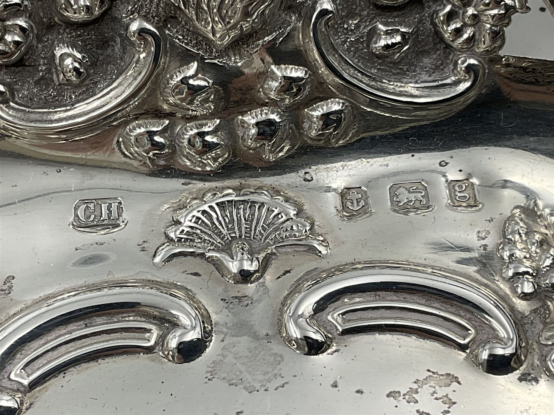 Edwardian silver swing handled basket, of navette form, with four repousse lion masks to each corner and with pierced and embossed floral, scroll and shell decoration to sides, base and handle, hallmarked Charles Horner, Birmingham 1906, height including handle H20cm