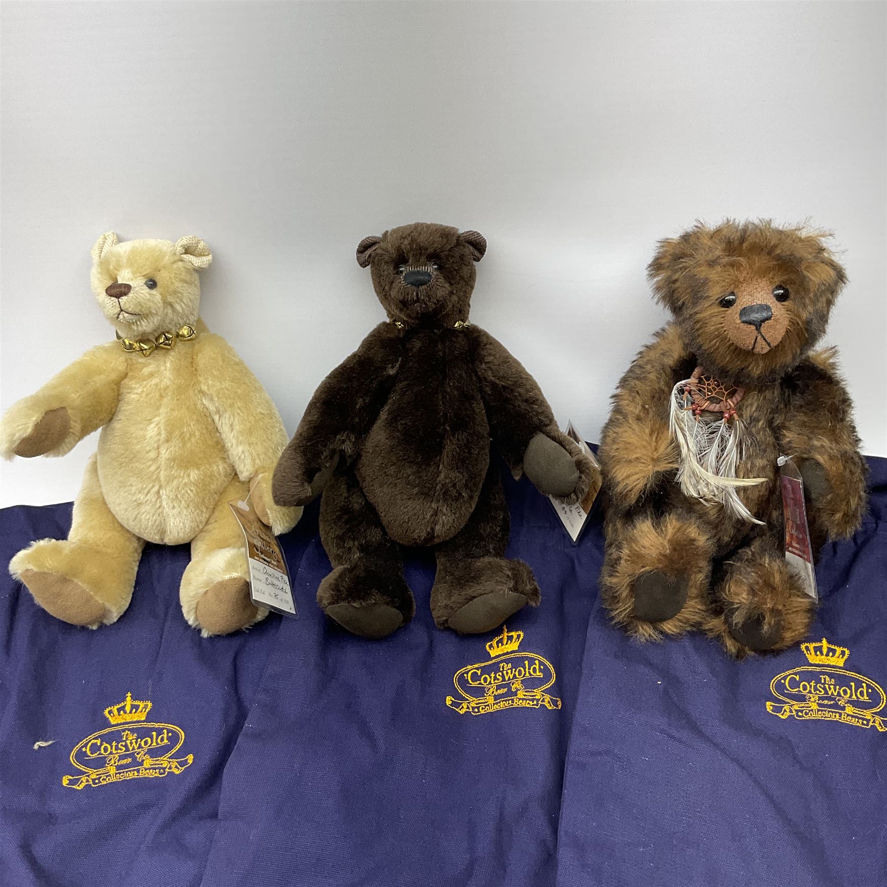 Three Cotswold Bear Company limited edition teddy bears - two in the Artists Gallery Series, 'Truffle' No.44/100 H28cm and 'Butterscotch' No.75/100; and Wild Collection Series 'Rocky' No.16/100; all with certificates and bags (3)