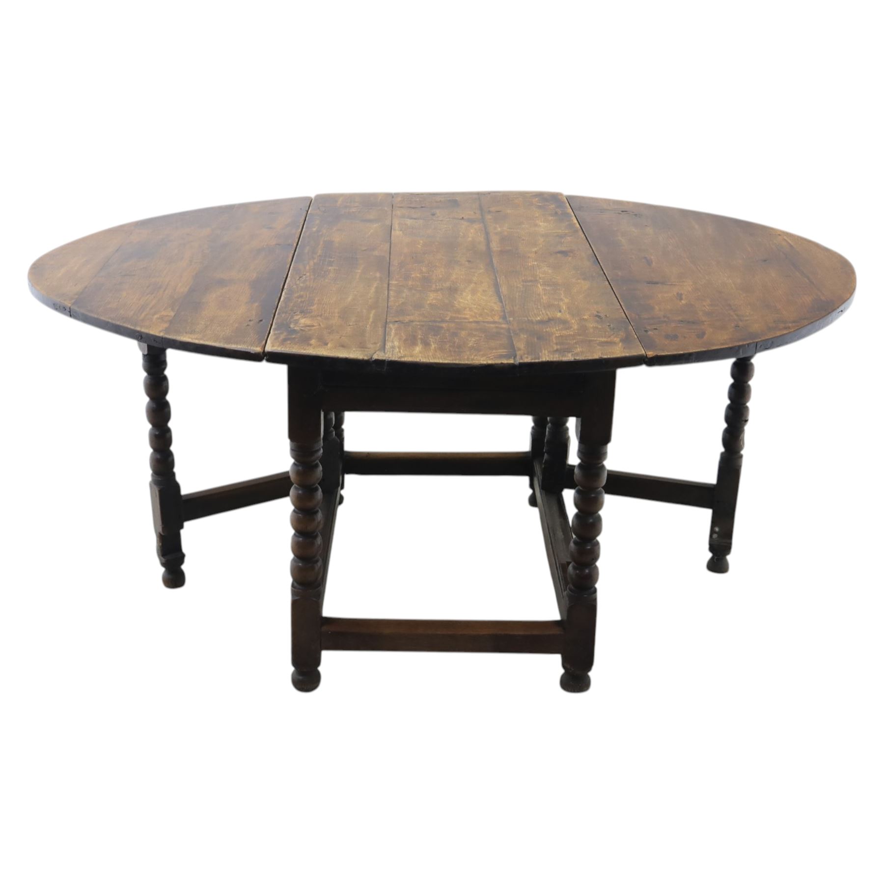 18th century country oak oval dining table, plank top with two drop leaves and gate-leg action, single drawer, raised on bobbin turned legs