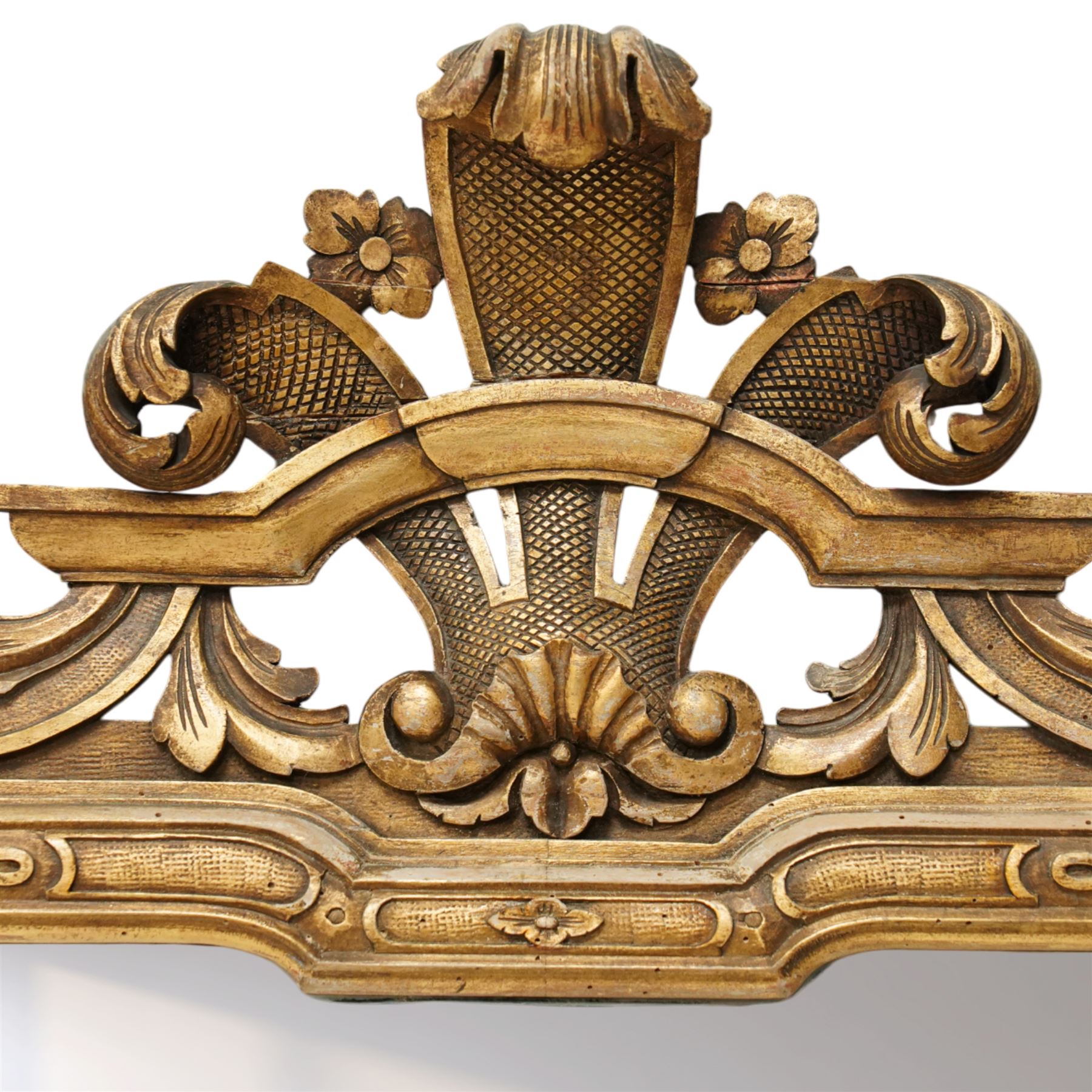 Georgian design giltwood overmantel mirror, arched rectangular plate within a moulded frame, the cresting carved with scrolling acanthus and shell motifs, trailing foliate decoration continuing to the shoulders and lower apron