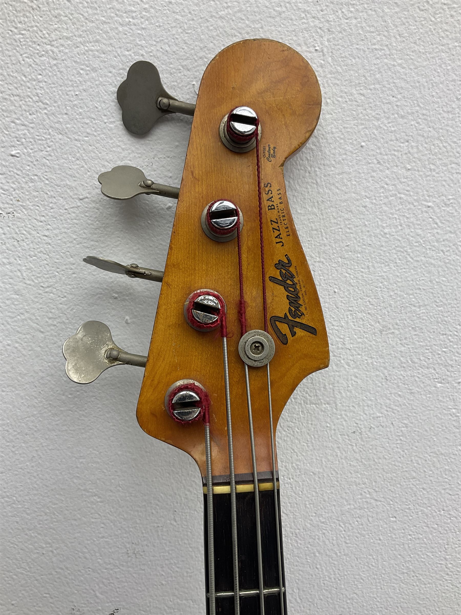 1963 Fender Jazz three-knob bass guitar; impressed with date code 7AUG63A on end of neck and serial no.L08587 on back plate; all original but re-finished in white in the 1970s; sold with photographs of the instrument in the 1960s with original finish and in the 1970s re-finished; L117.5cm; in original hard carrying case; Provenance: the professional guitar of Howard Livett from new to his death in 2005. Howard played in The Humperdincks, the backing group for Englebert Humperdinck, also played in the backing group for Max Bygraves and in the band Hedgehoppers Anonymous. The guitar is also sold with a manuscript letter of provenance from Howard's wife.