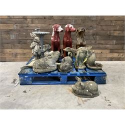 Various cast stone and composite garden ornaments, to include Peter Rabbit, goose, pigs, dogs, dog with wheelbarrow, painted metal bird bath and other, on two pallets