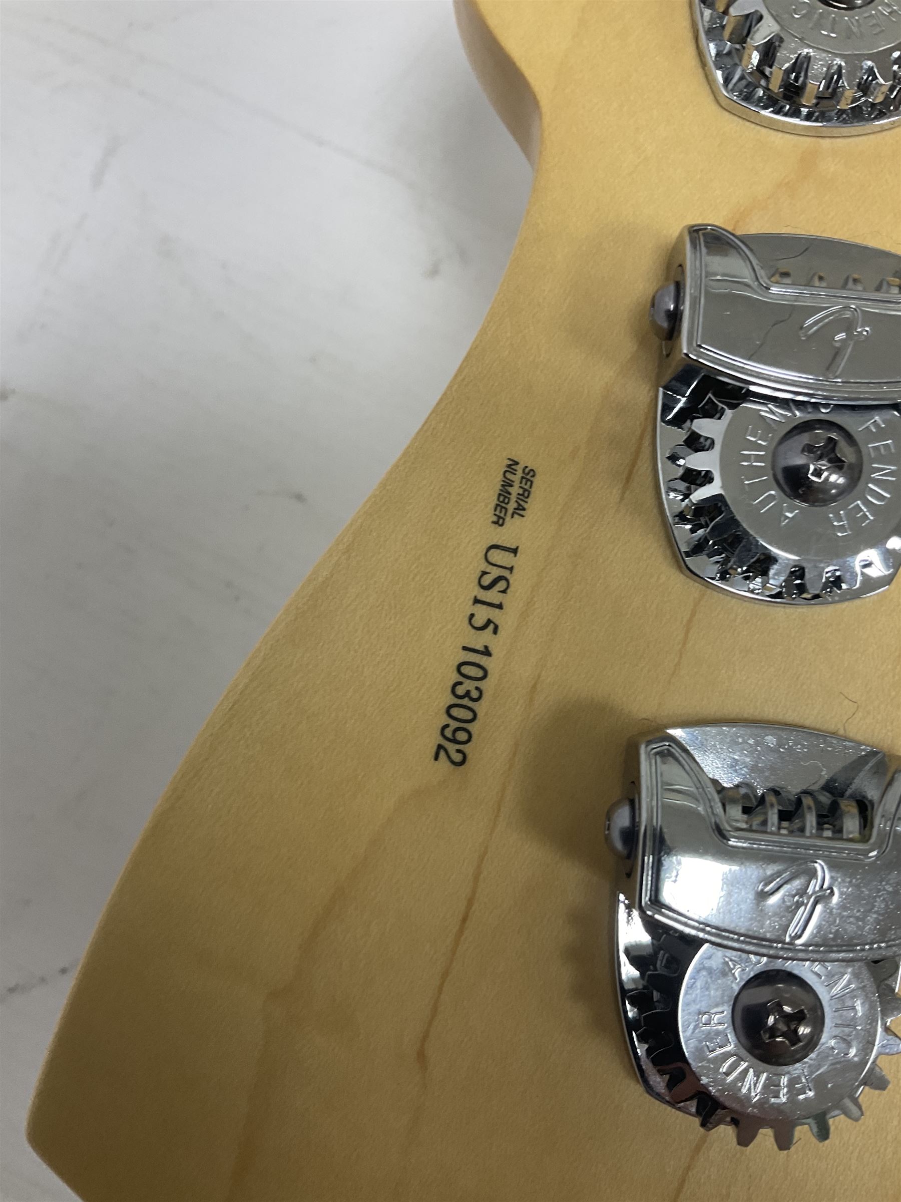 Fender Precision Bass guitar, in Olympic White finish with tortoiseshell effect scratchboard, serial no US15103092, in black Fender hard case with Fender strap and warranty card, guitar L116cm