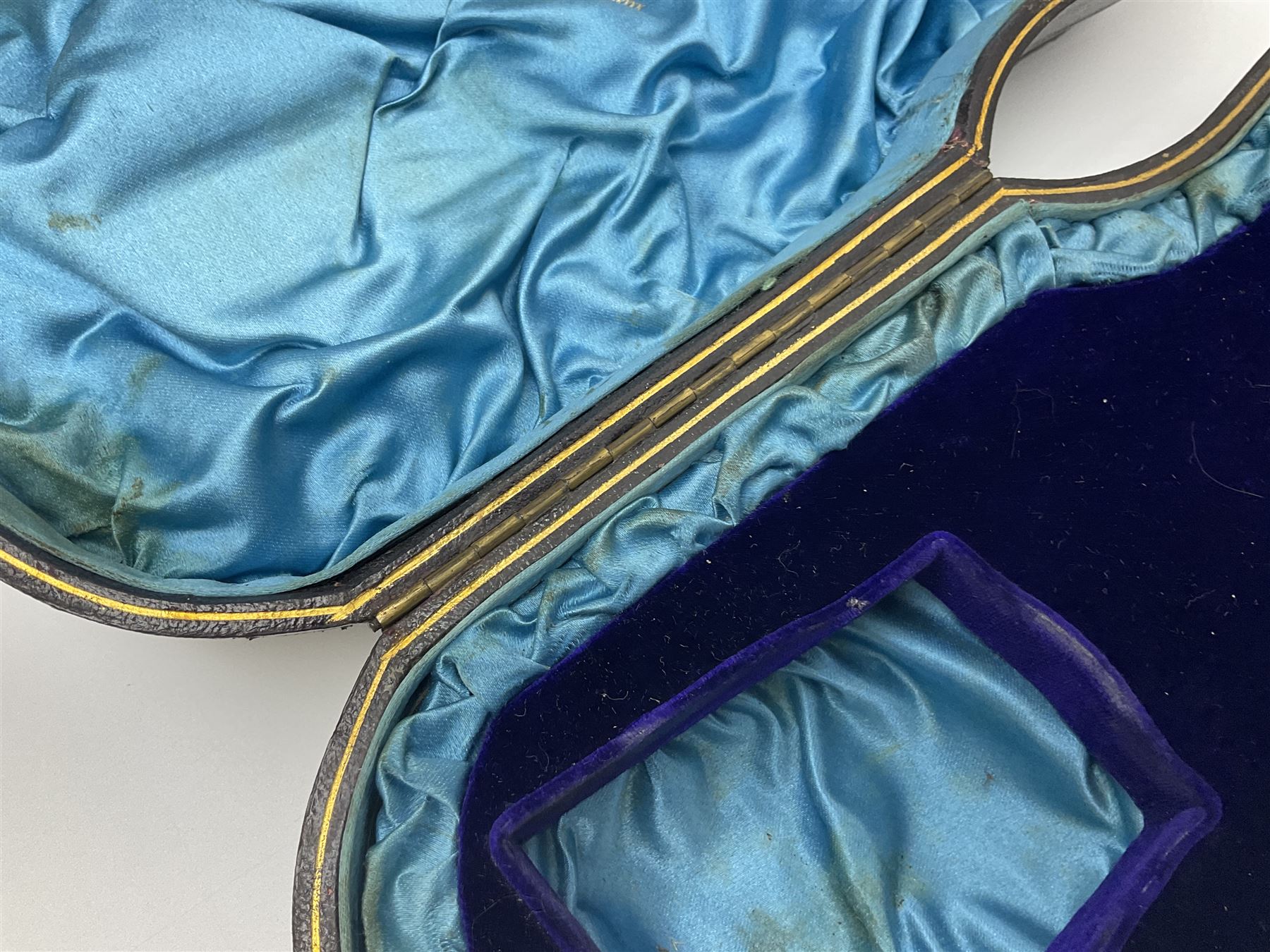 Victorian three-piece silver tea service, comprising teapot, twin handled open sucrier and milk jug, of oval form with shaped rim and C handles, each engraved with crests and bands of strapwork decoration, the milk jug and sucrier with gilt interiors, hallmarked Josiah Williams & Co, Exeter 1881, the teapot with ivory insulators and finial, all contained with a tooled leather, blue silk and velvet lined fitted case, retailed by West & Sun, Dublin 
This item has been registered for sale under Section 10 of the APHA Ivory Act