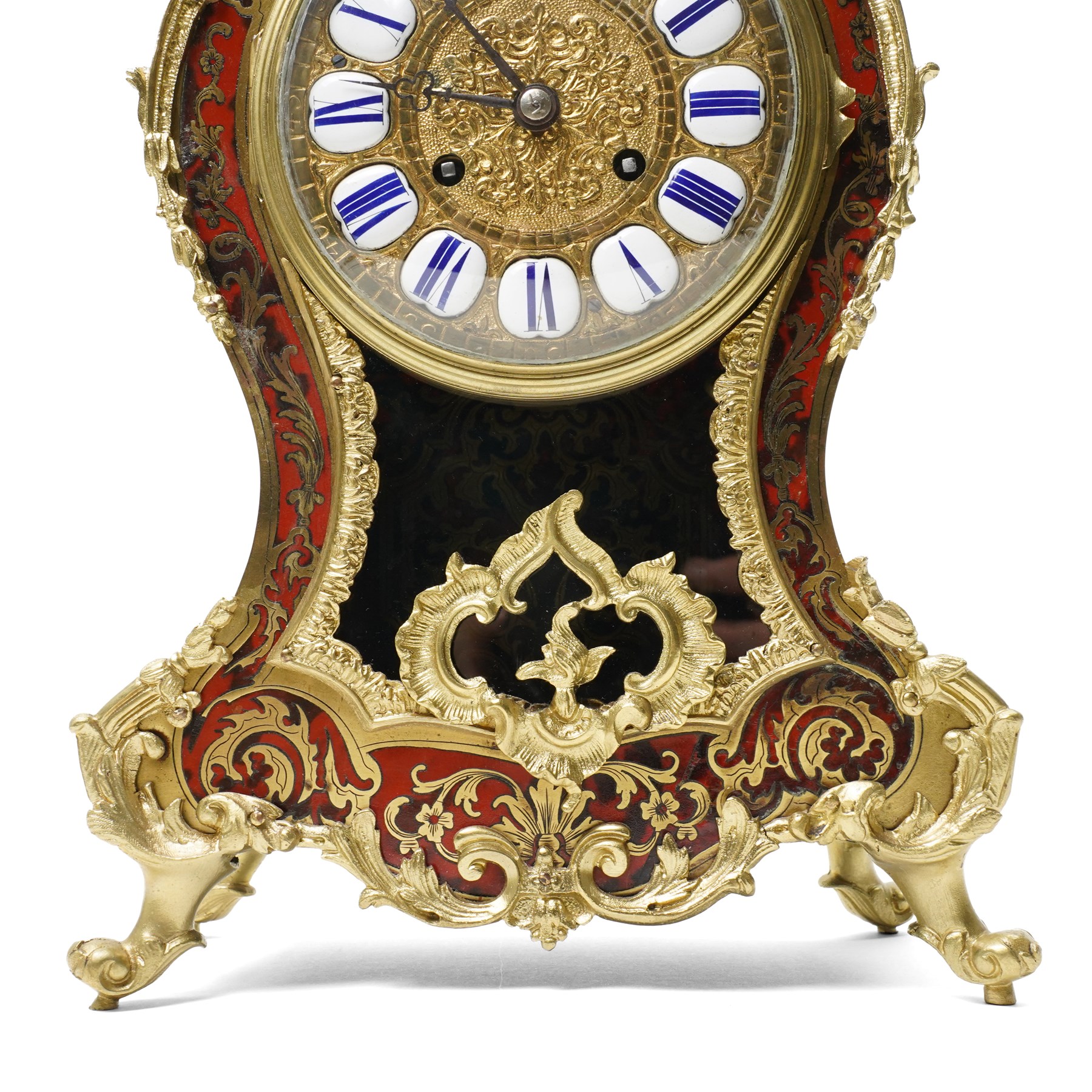 Rollin à Paris - 19th century French Louis XV style ormolu-mounted red tortoiseshell and brass Boulle-work mantel clock, surmounted by a seated musical putto above a waisted case applied with mask, rocaille, foliate and dolphin mounts, the gilt dial with white enamel Roman numeral cartouches, twin-train movement striking on a bell, signed and numbered 480, on four scrolling foliate feet