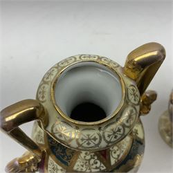 Pair of Vienna style twin handled urns and covers, decorated with figural scene on green, red and white ground with gilt highlights, stamped with beehive mark beneath, H25cm