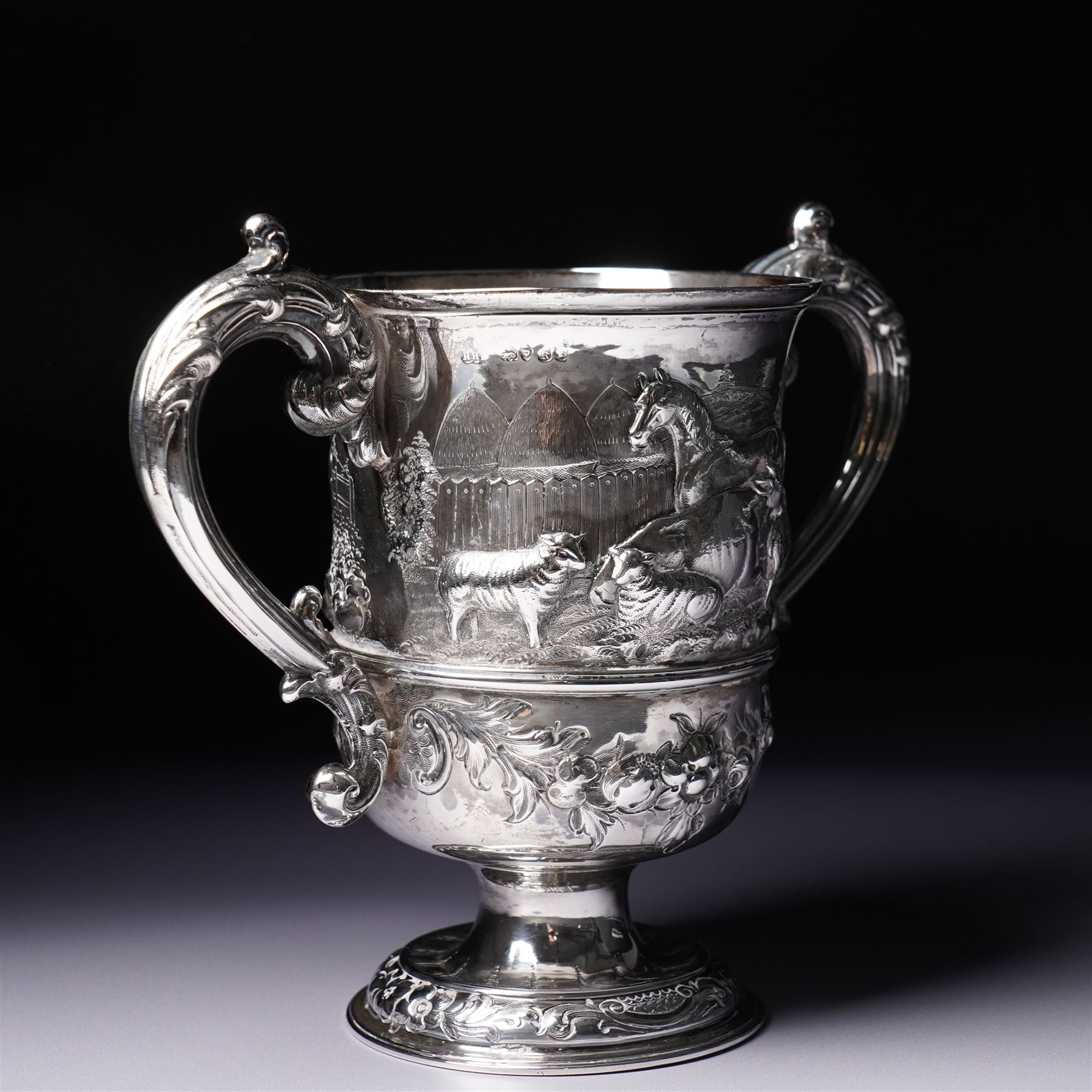 Victorian silver two handled cup embossed with cattle, horses and sheep and presented by Nottingham Mills Company to John Barugh, Thwing H16cm London 1865 Maker Henry Hollannd