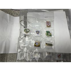 Large collection of approximately one hundred and eighty enamel badges and pins, relating to British and World football clubs, including loose examples and examples housed in folders, mostly identified