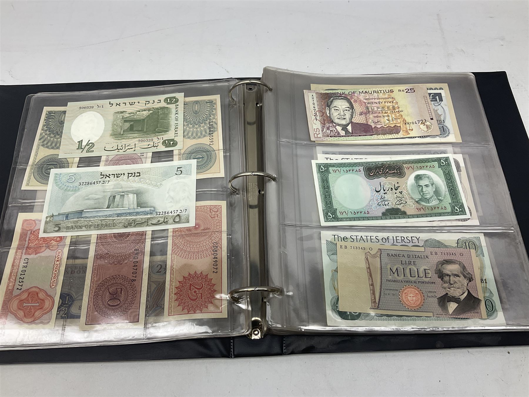 World banknotes, including Queen Elizabeth II The States of Jersey one pound 'DB202703', five pounds 'BB527762' and ten pounds 'AB651481', reserve bank of New Zealand two dollars '1L3 741894', King George V Straits Settlements one dollar 1st January 1935 'F/83 28924', various Bank of England notes etc, housed in two ring binder albums